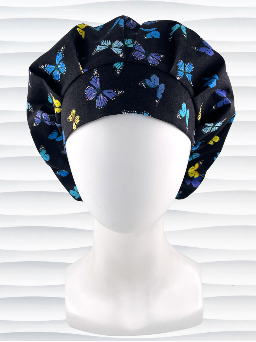 Bouffant style surgical scrub cap hat with blue, purple, and yellow butterflies all over black cotton fabric.