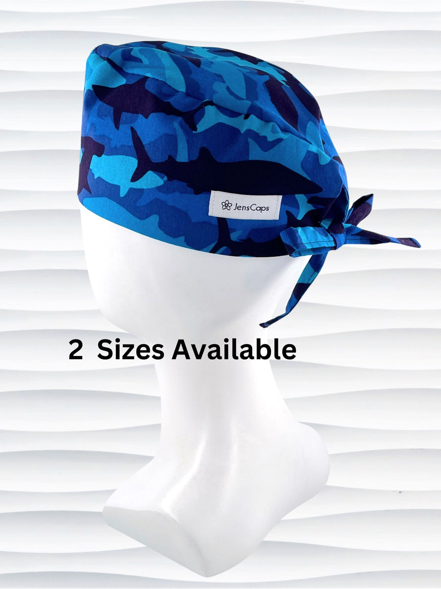 Surgeon mens style surgical scrub cap hat with blue and black sharks in camoflauge style on blue cotton fabric.