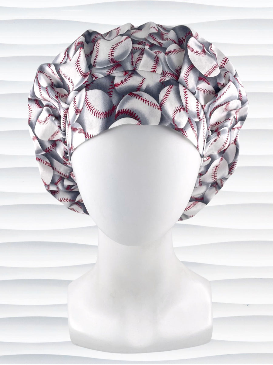 Bouffant style surgical scrub cap hat with iconic baseballs tossed on this premium cotton fabric.