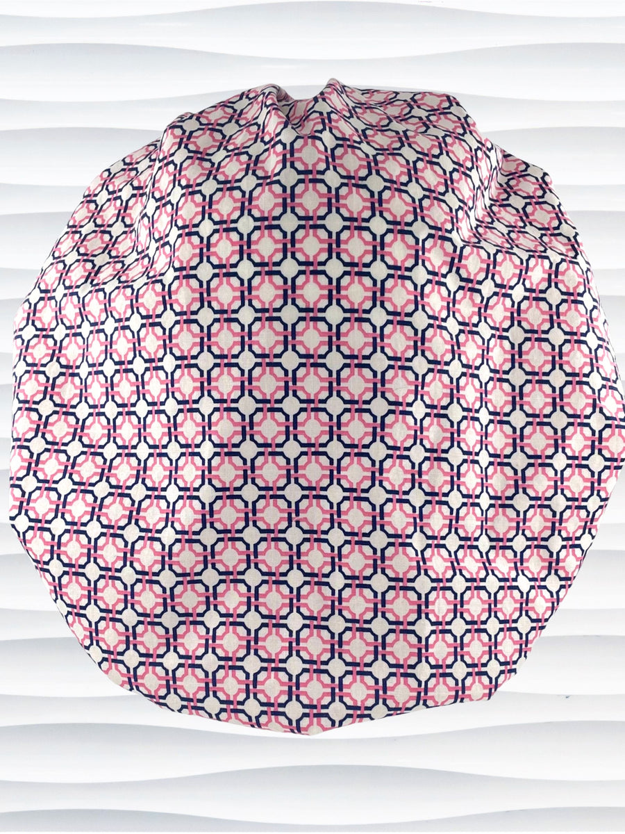 Bouffant style surgical scrub cap hat with pink and blue circles and squares in a trellis pattern on cotton fabric.