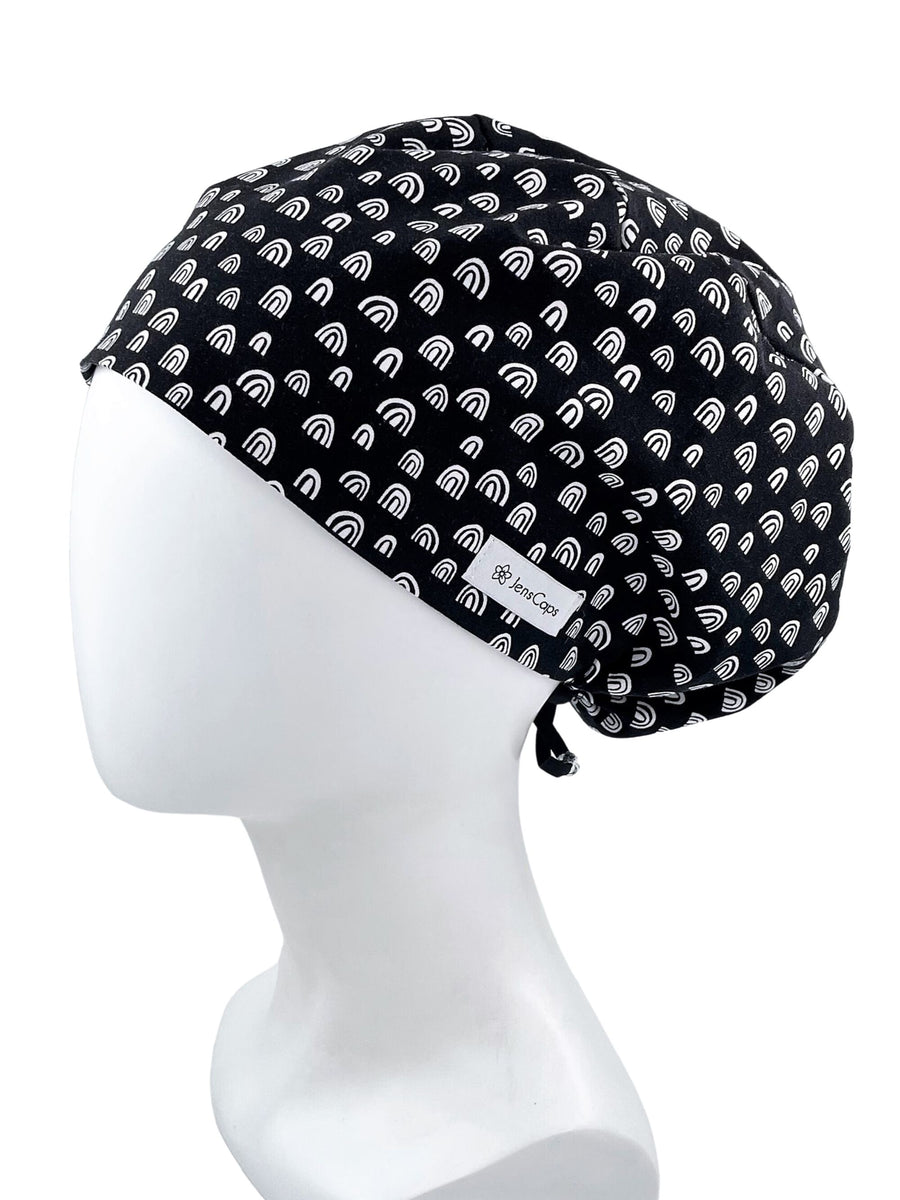 Euro Pixie style surgical scrub cap hat with white MCM bohemian arches rainbows on black premium cotton fabric.