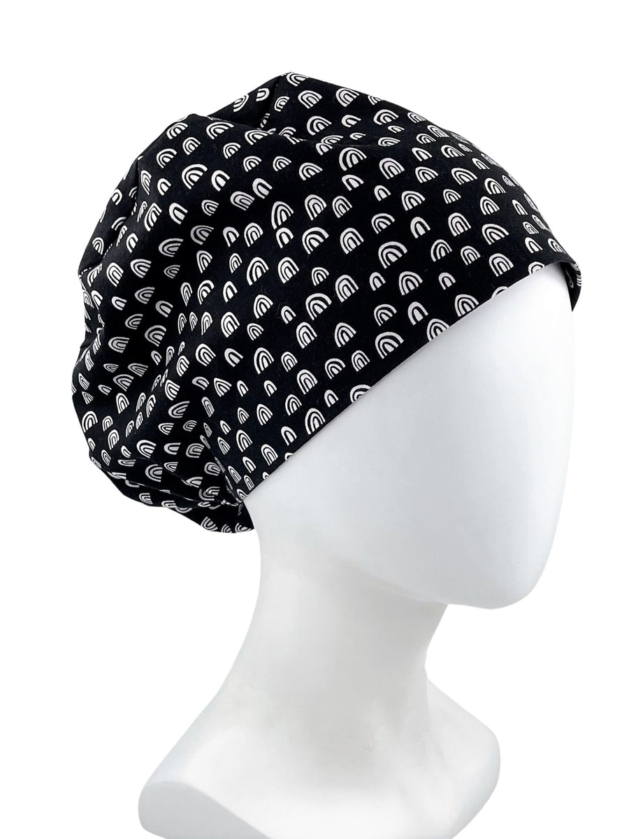 Euro Pixie style surgical scrub cap hat with white MCM bohemian arches rainbows on black premium cotton fabric.