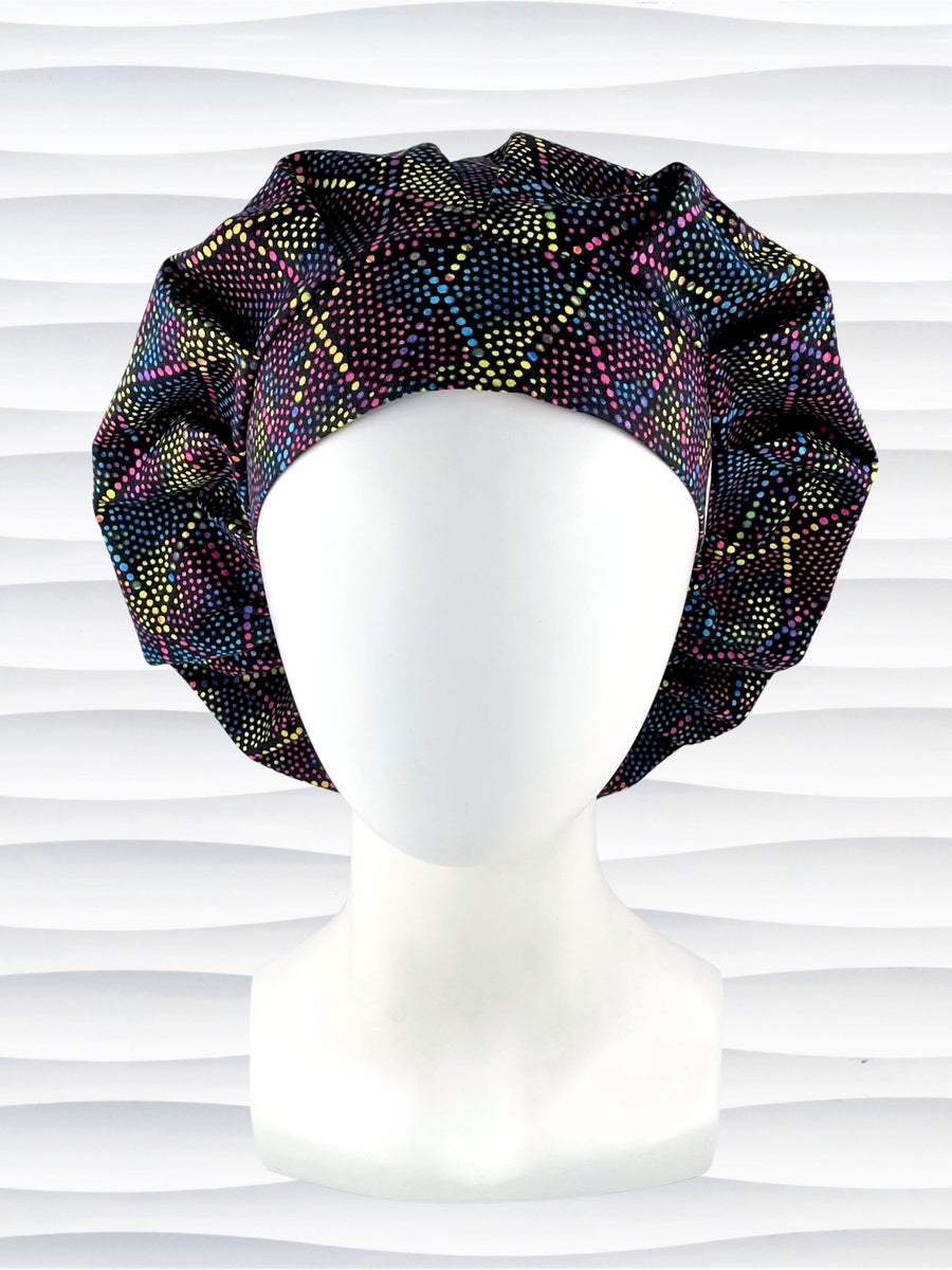 Bouffant style surgical scrub cap hat with abstract dots and lines in diamond shapes in bright colors on black cotton fabric.