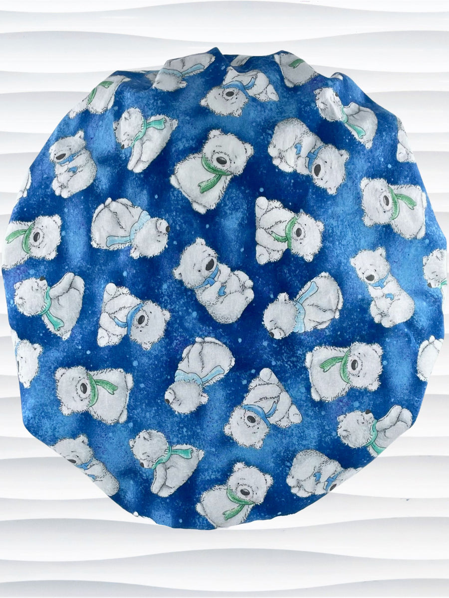 Bouffant style surgical scrub hat cap with white fluffy teddy bears wearing winter scarves all over this blue cotton fabric.