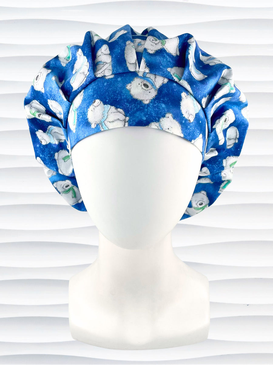 Bouffant style surgical scrub hat cap with white fluffy teddy bears wearing winter scarves all over this blue cotton fabric.
