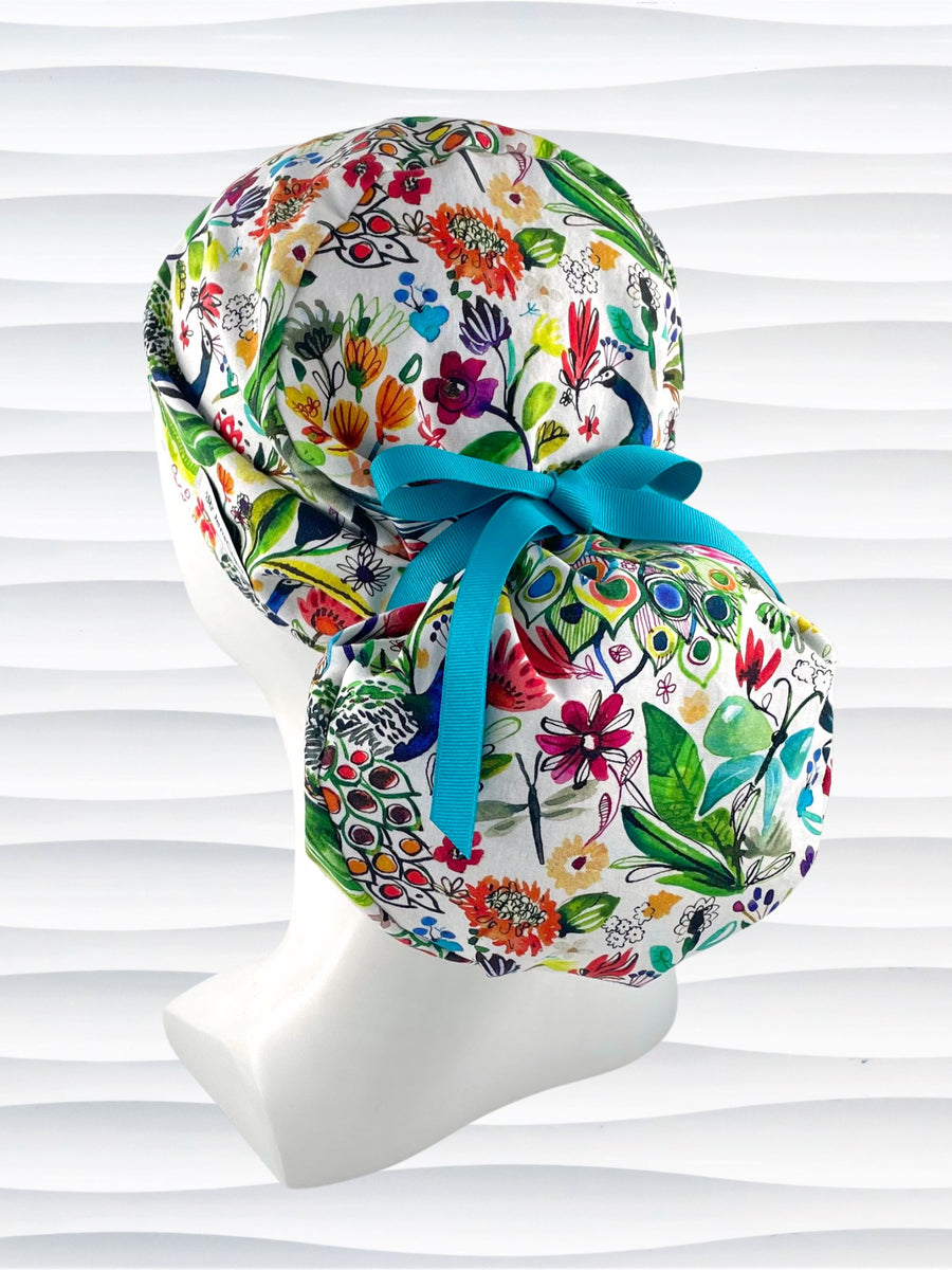 Pony surgical scrub cap hat for locs, braids, and thick hair with bright flowers and peacocks on white cotton premium fabric.