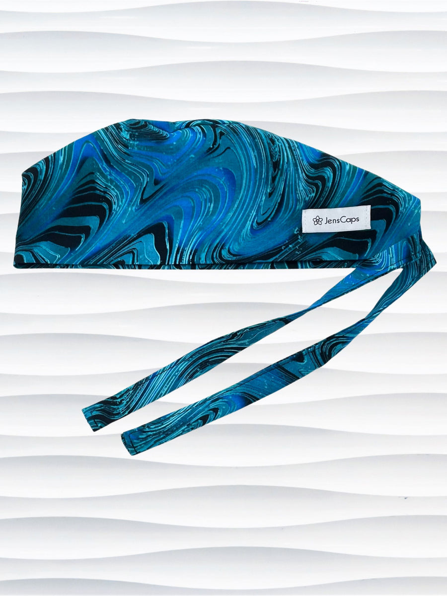 Surgeon style surgical scrub cap hat with a blue pattern of lines and swirls that look like rogue waves on black cotton fabric.