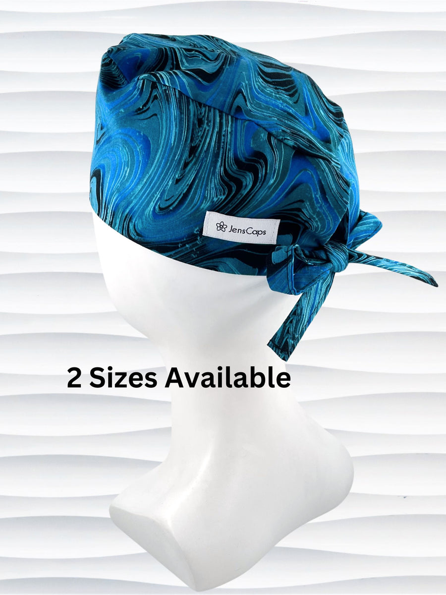 Surgeon style surgical scrub cap hat with a blue pattern of lines and swirls that look like rogue waves on black cotton fabric.