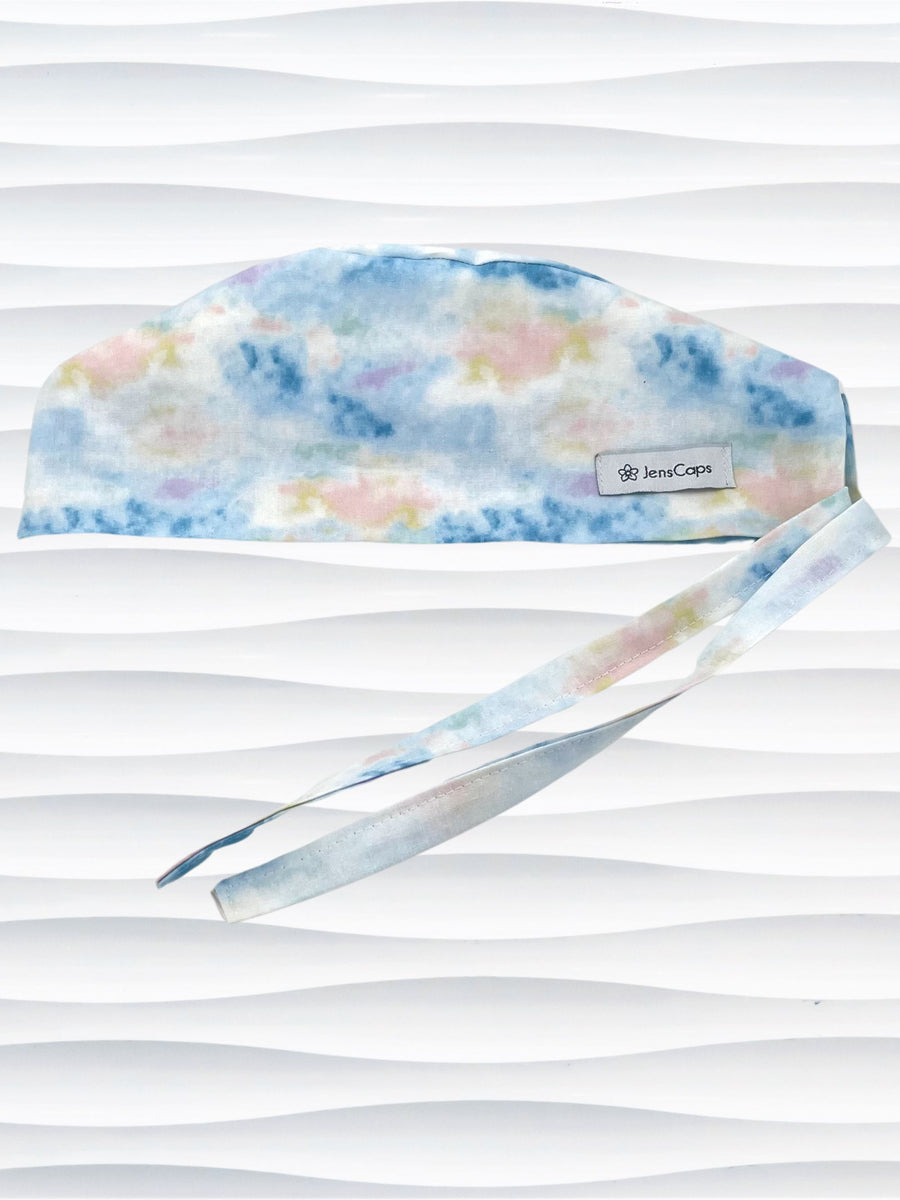 Surgeon style surgical scrub cap hat with an allover look of a sunrise in clouds on cotton fabric.