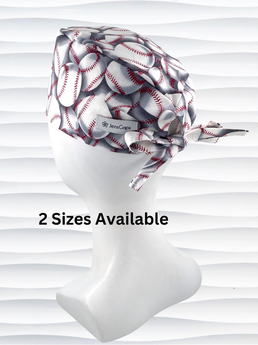 Surgeon style surgical scrub cap hat with an allover print of white baseballs with red stitching and gray shadows on cotton fabric.