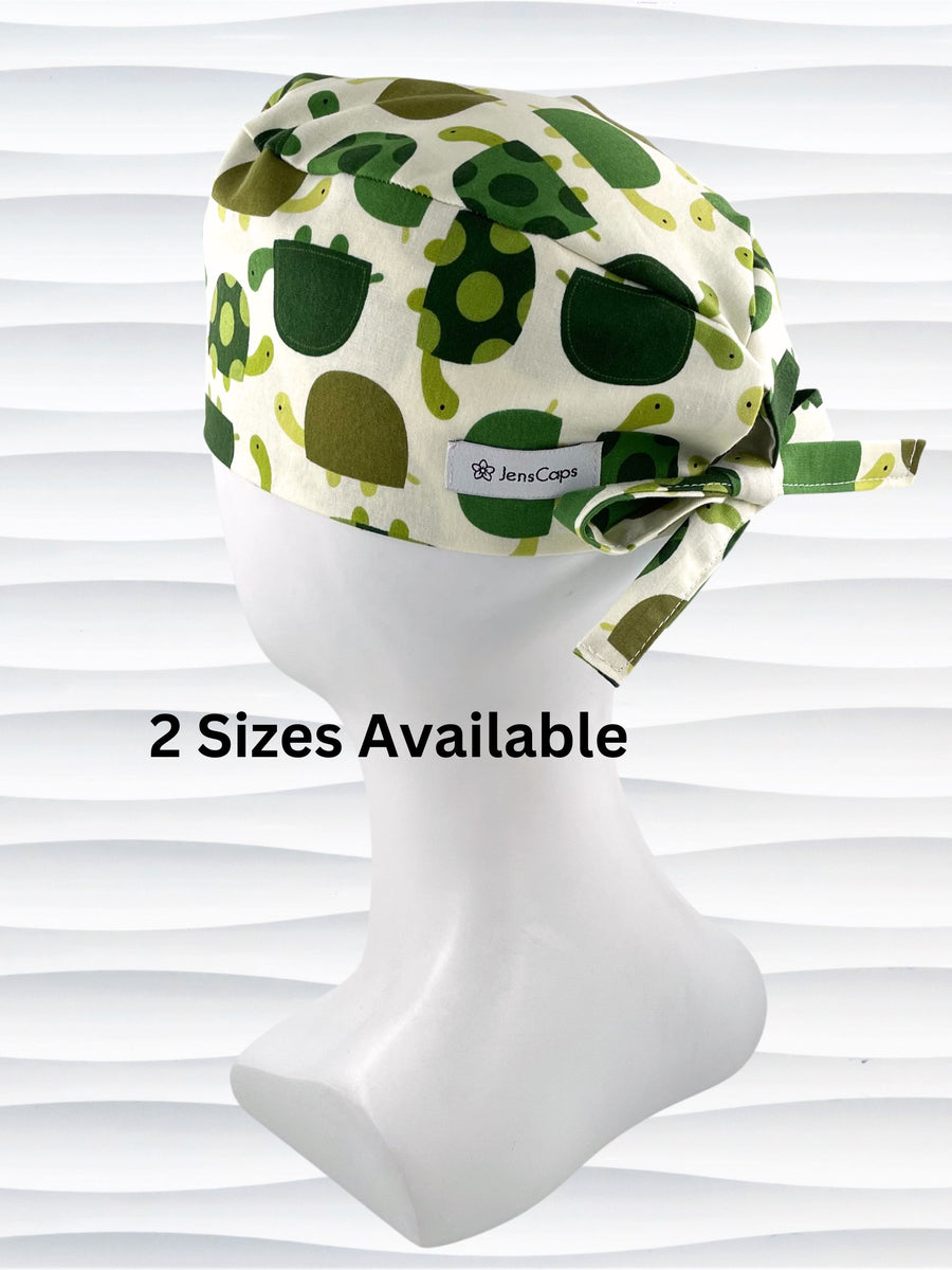 Surgeon style surgical scrub cap hat with an allover pattern of green cartoon turtles with dots on cotton fabric.