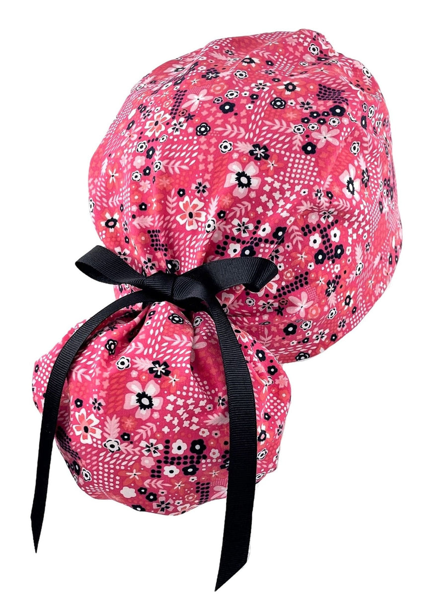 Ponytail surgical scrub cap hat with pink white flowers on pink premium cotton fabric.