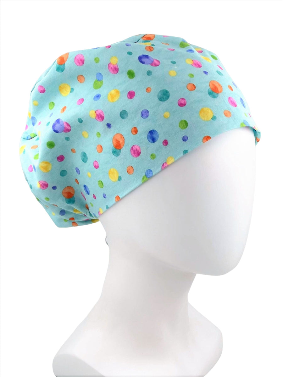 Euro Pixie style surgical style scrub cap hat with colorful circles on light blue premium cotton fabric.