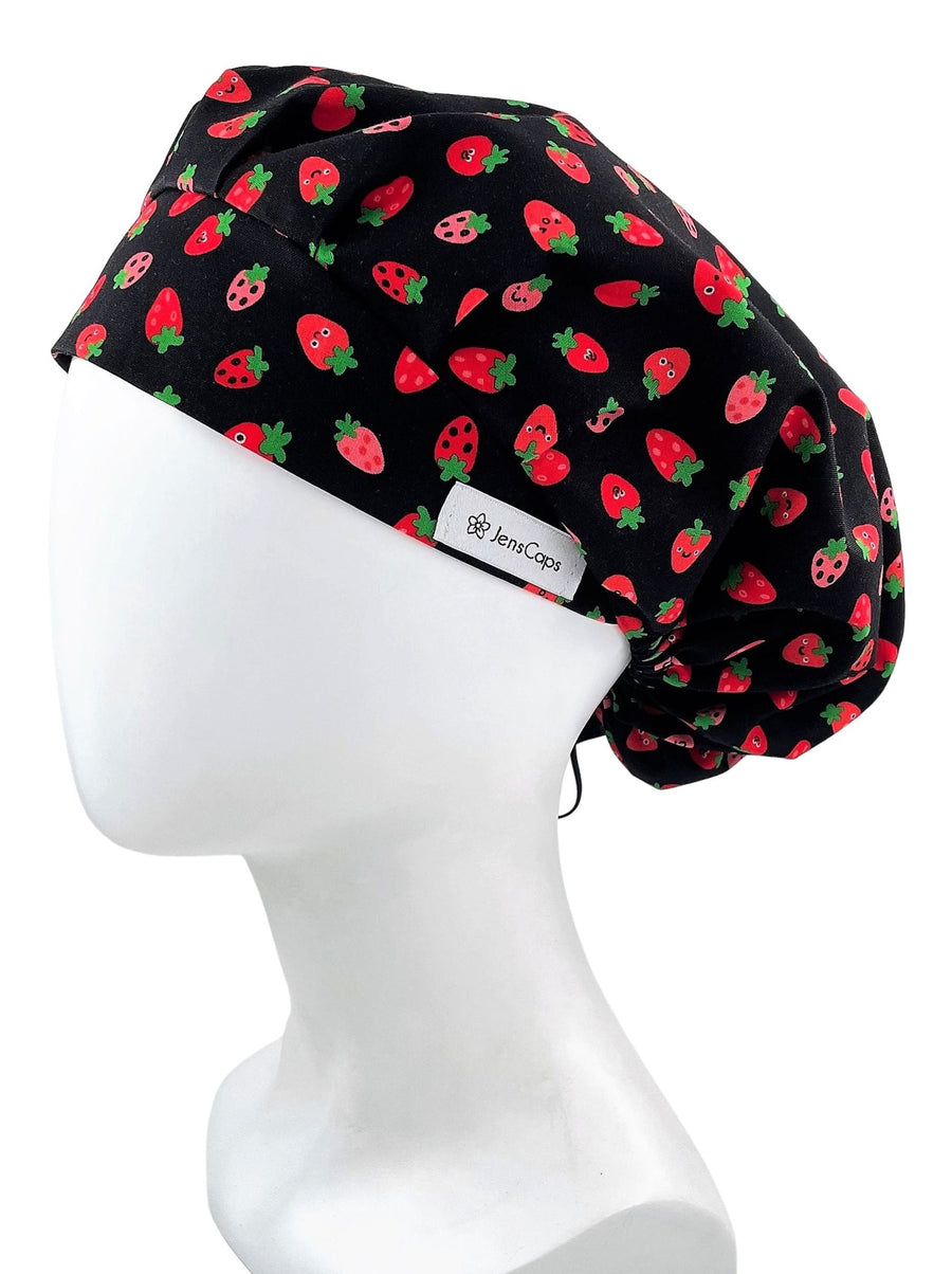 Bouffant style scrub cap with red strawberries and green stems on black premium cotton fabric.