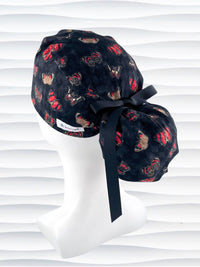Ponytail style surgical scrub cap hat with red and black butterflies on a black harquin patterned background cotton fabric.