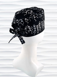 Surgeon style surgical scrub cap hat with dancing skeletons in white and gray on black cotton fabric.