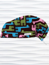 Euro Pixie style surgical scrub cap with cute giraffes with stripes or dots in blue, pink, and green all over a dark brown background on cotton fabric.