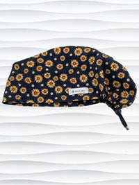 Euro Pixie style surgical scrub cap hat with sunflowers tossed all over black textured background cotton fabric.