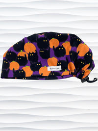 Euro Pixie style surgical scrub cap by JensCaps with black puffy cats in a pumpkin patch on purple background cotton fabric.