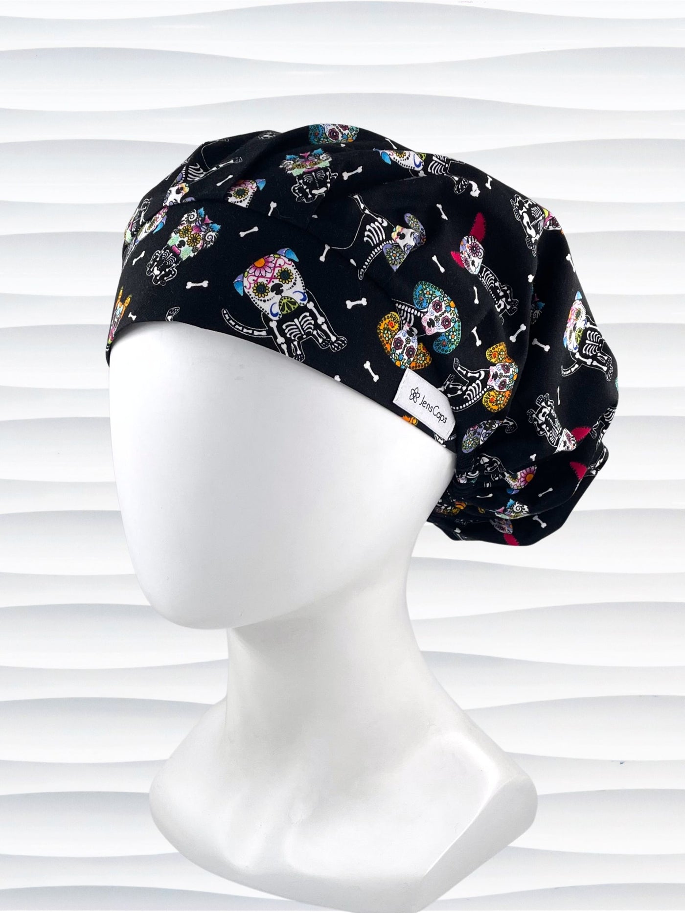 Bouffant style surgical scrub cap hat with sugar skull dogs in bright colors on black cotton fabric.