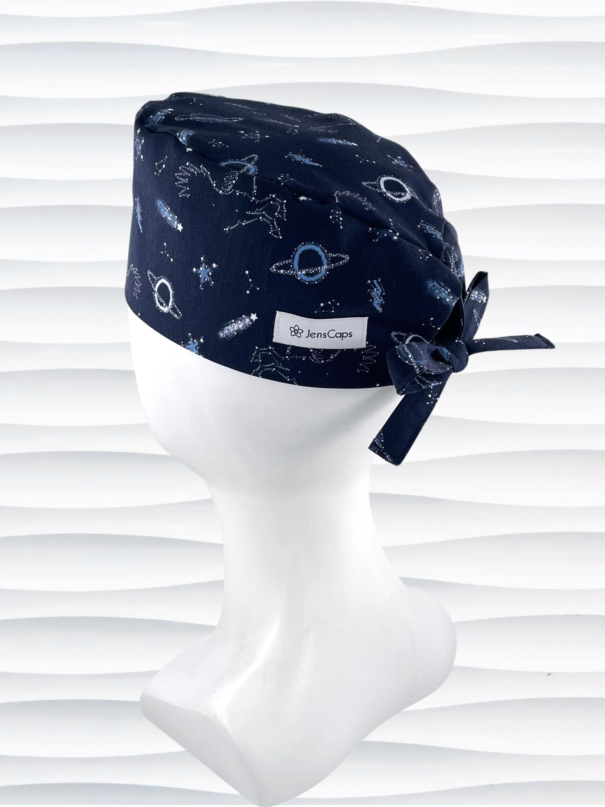 Mens Surgeon style surgical scrub cap hat with shooting stars, planets, constellations, and Pegasus in white and light blue on a dark blue cotton fabric.