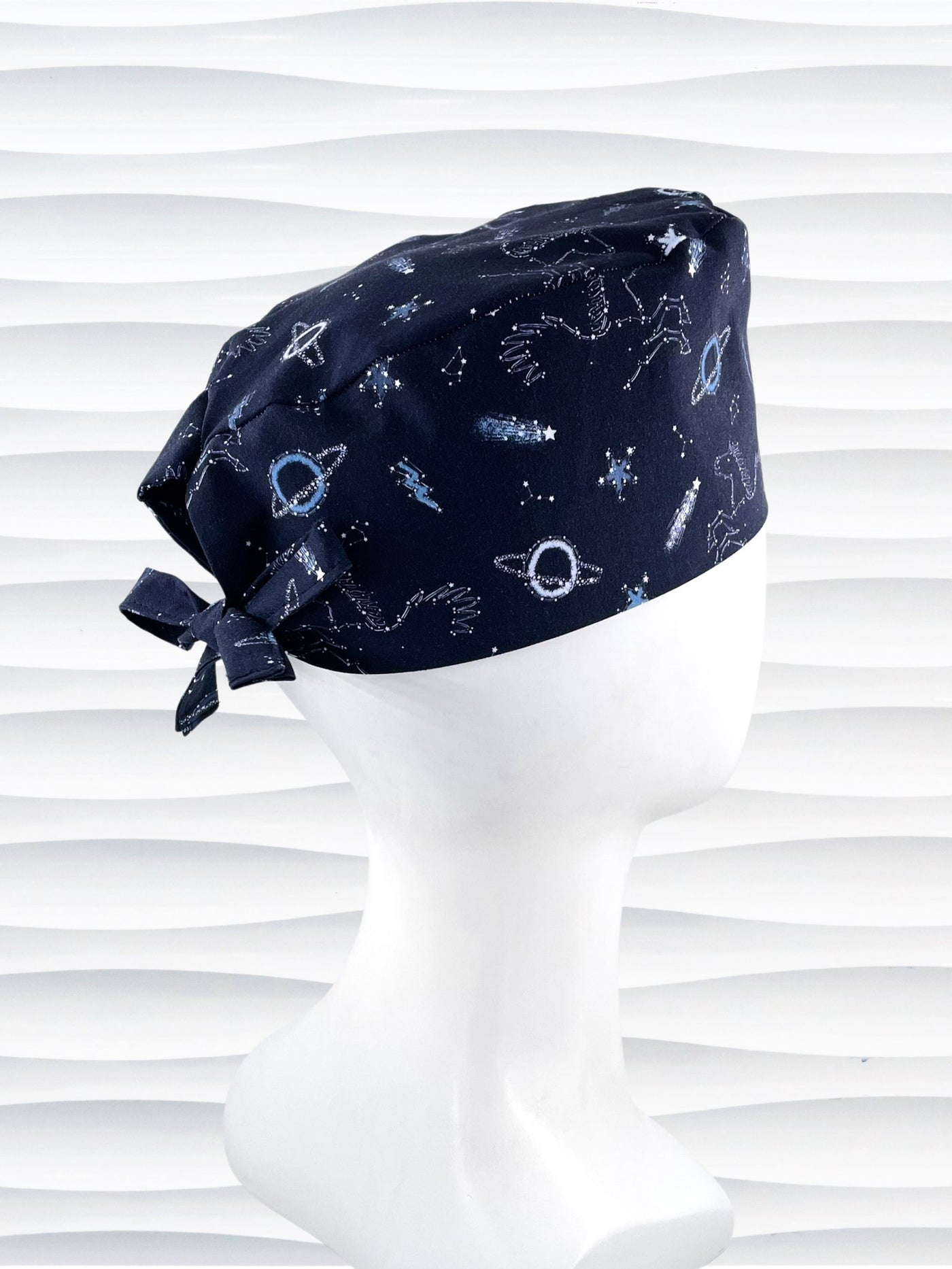 Mens Surgeon style surgical scrub cap hat with shooting stars, planets, constellations, and Pegasus in white and light blue on a dark blue cotton fabric.