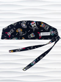 Mens surgeon style surgical scrub cap hat with sugar skull dogs in bright colors all over black cotton fabric.