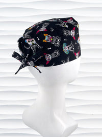 Mens surgeon style surgical scrub cap hat with sugar skull dogs in bright colors all over black cotton fabric.