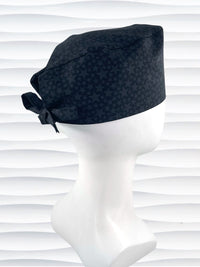 Mens surgeon style surgical scrub cap hat with an all over print of black stars on black cotton fabric.