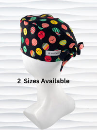 Mens surgeon style surgical scrub cap hat with christmas ornaments with smiling faces or stripes in red, green, and yellow on black cotton fabric.