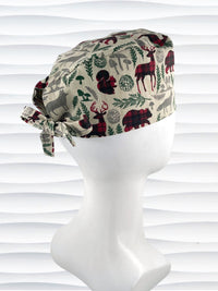 Mens surgeon style scrub cap with deer, bears, foxes, and trees in holiday inspred colors all over this cotton fabric.