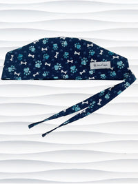 Mens Surgeon style scrub cap hat with white dog bones, blue dog paws, and blue hearts on dark blue cotton fabric.