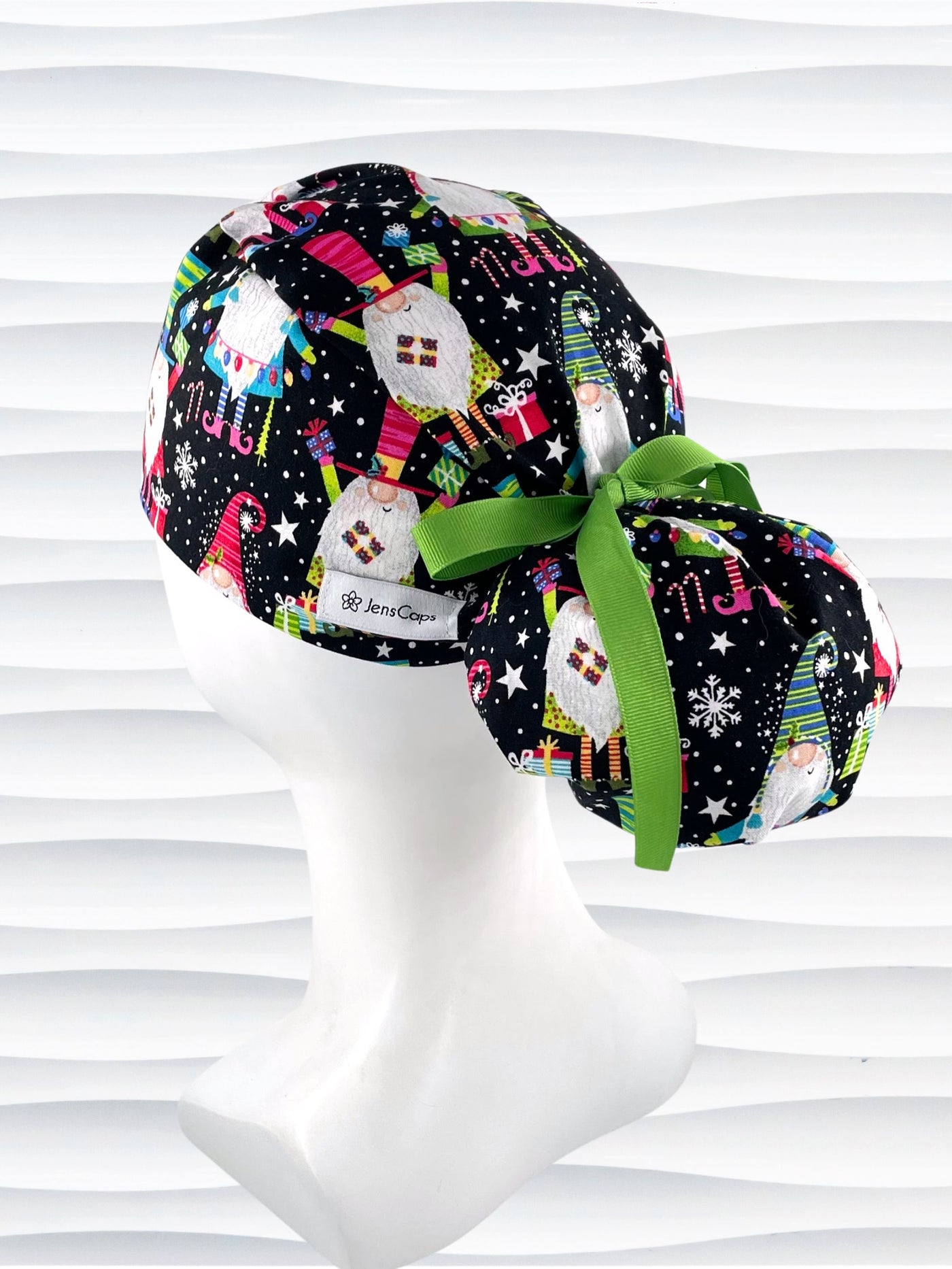 Ponytail style surgical scrub cap hat with christmas gnomes, stars, confetti, and gifts in bright colors on black cotton fabric.