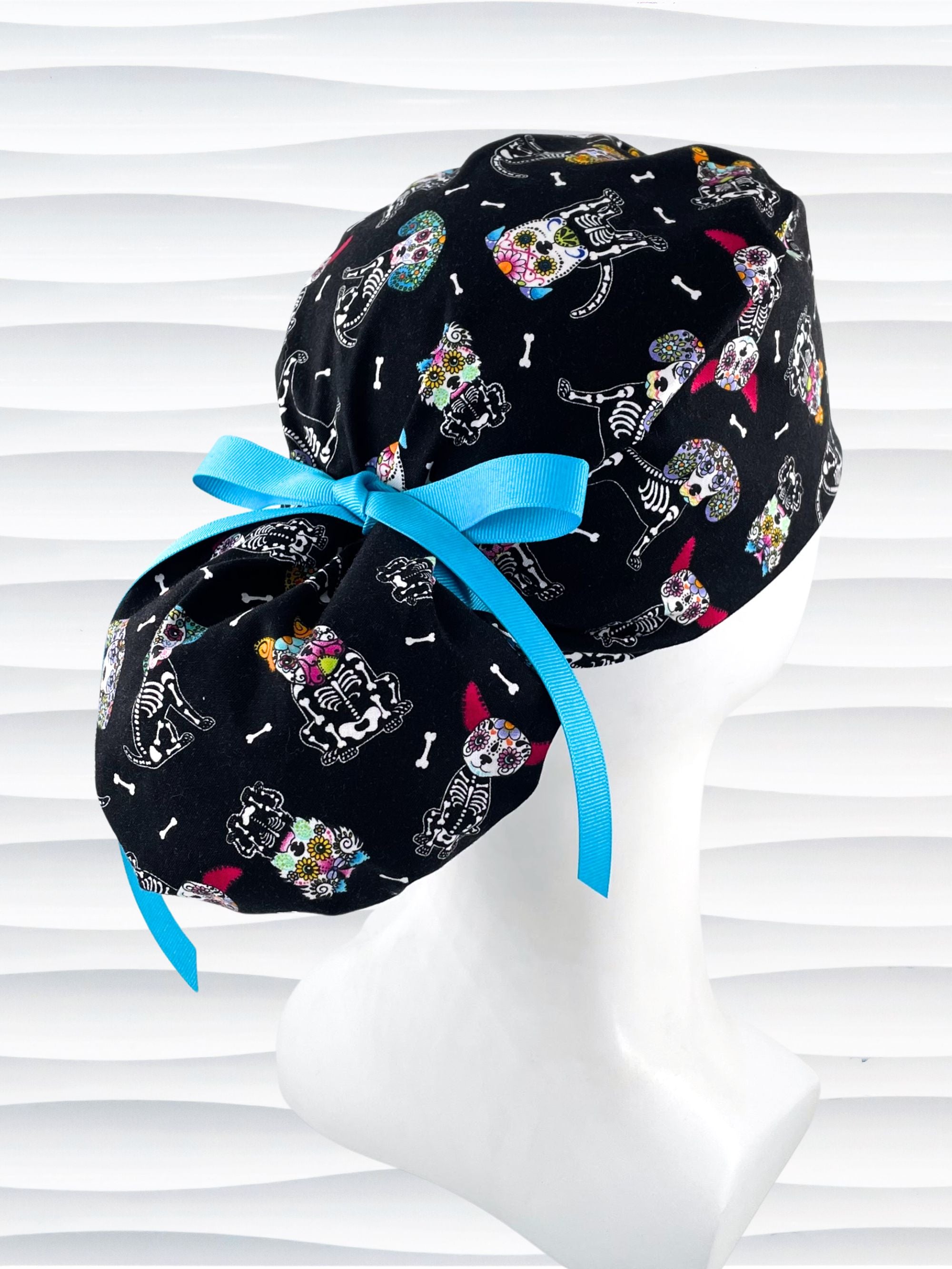 Euro Pony style surgical scrub cap hat for long hair with sugar skull dogs in bright colors on black cotton fabric.