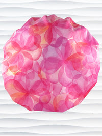 Bouffant style surgical scrub cap hat with large flowers in light and dark pinks and peach sorbet on cotton fabric.