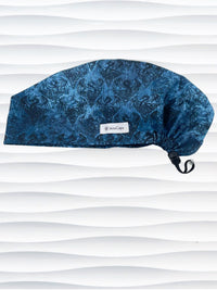 Euro Pixie style surgical scrub cap hat with subtle dragon shadows in blues and black on cotton fabric.