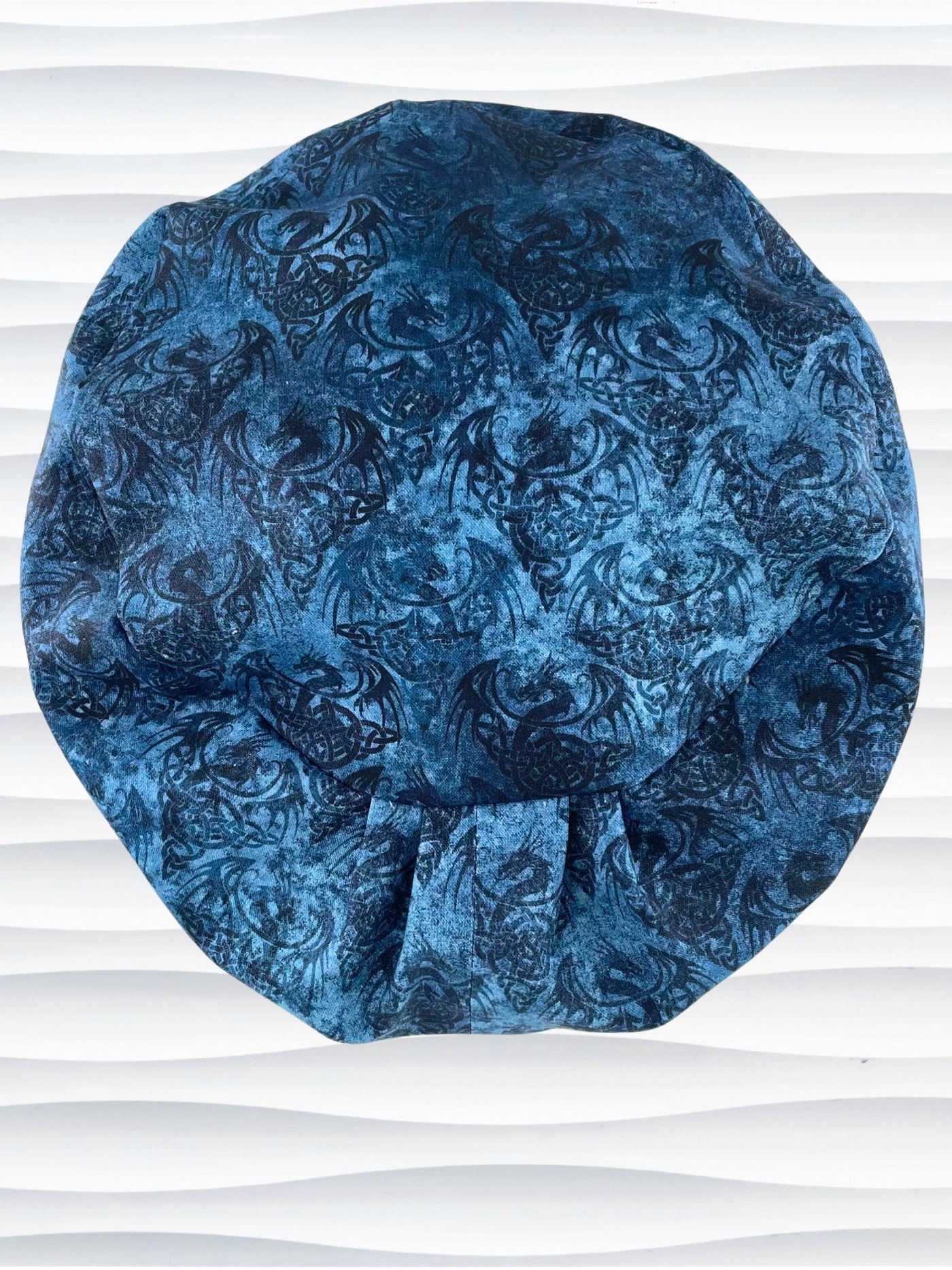 Euro Pixie style surgical scrub cap hat with subtle dragon shadows in blues and black on cotton fabric.