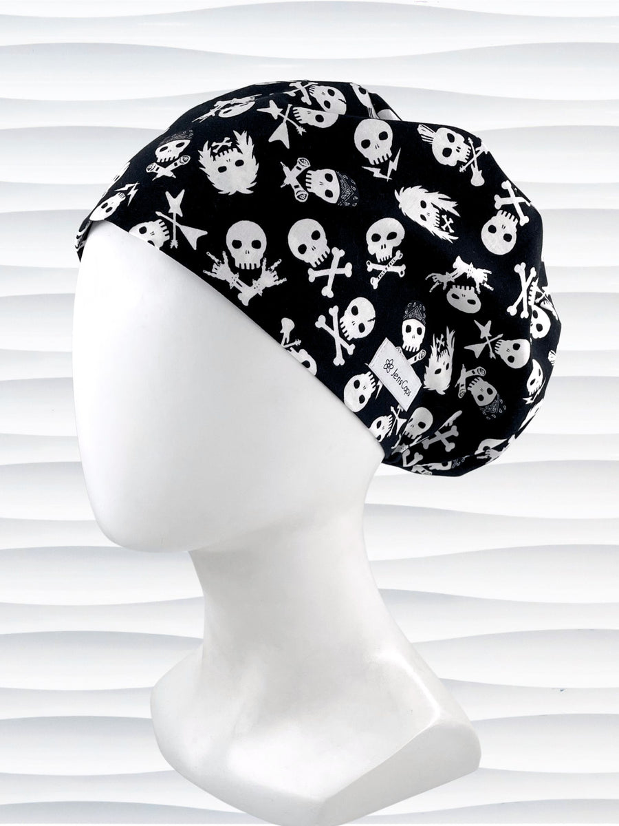 Euro Pixie style surgical scrub cap with white skulls, crossbones, and heavy metal hair all over this black cotton fabric.