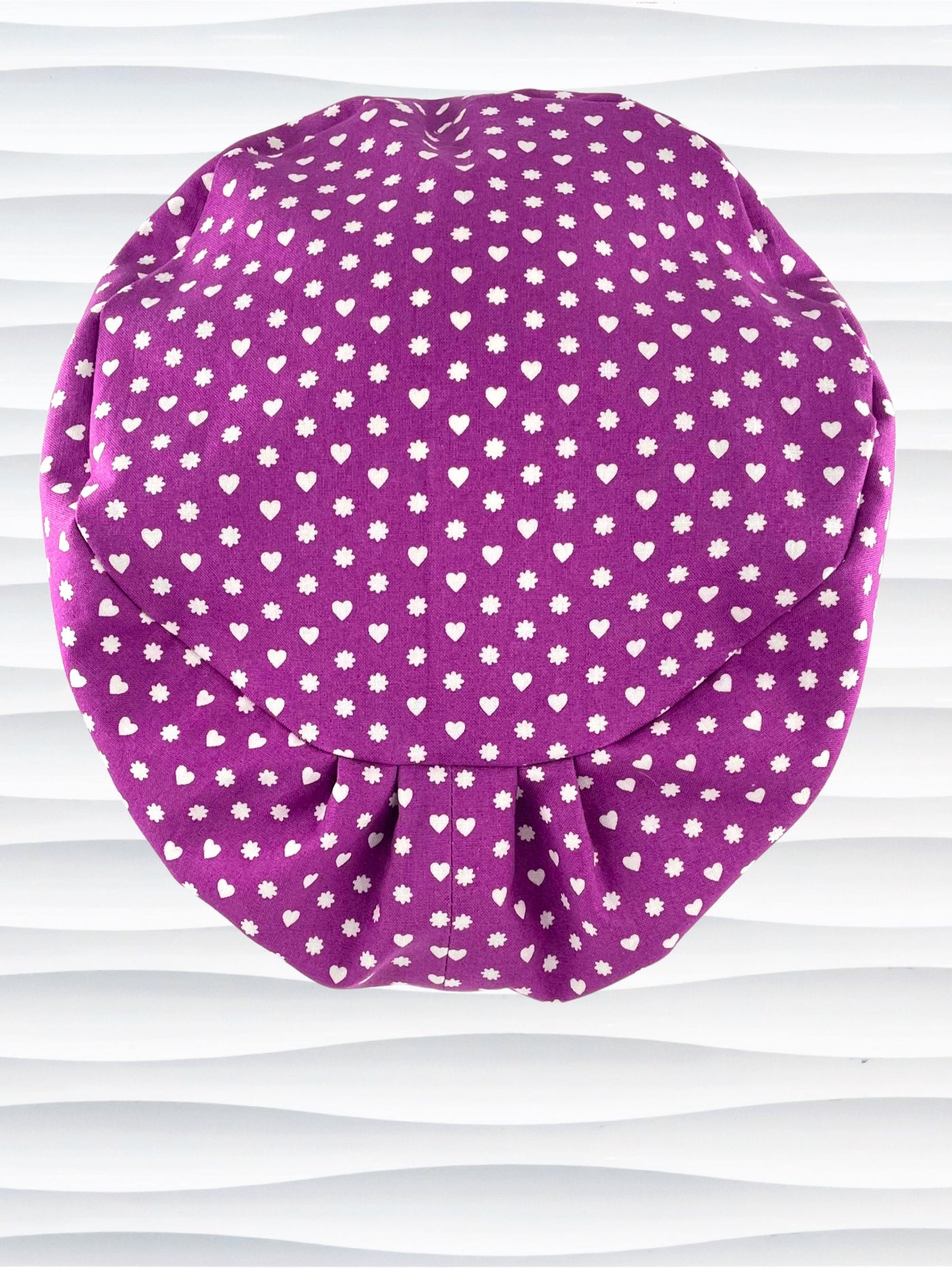 Euro Pixie style surgical scrub cap with small white hearts and daisies all over purple cotton fabric