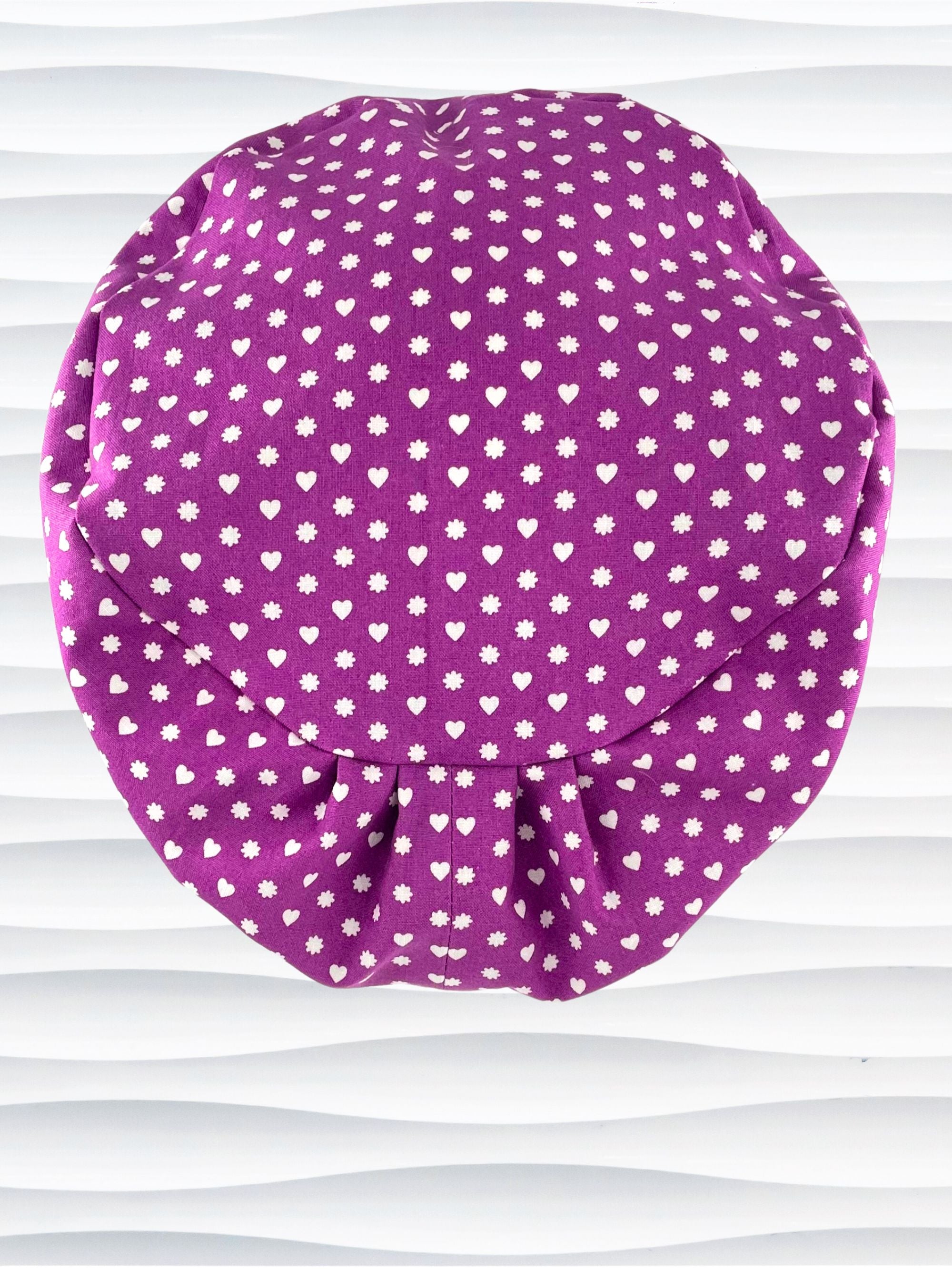 Euro Pixie style surgical scrub cap with small white hearts and daisies all over purple cotton fabric