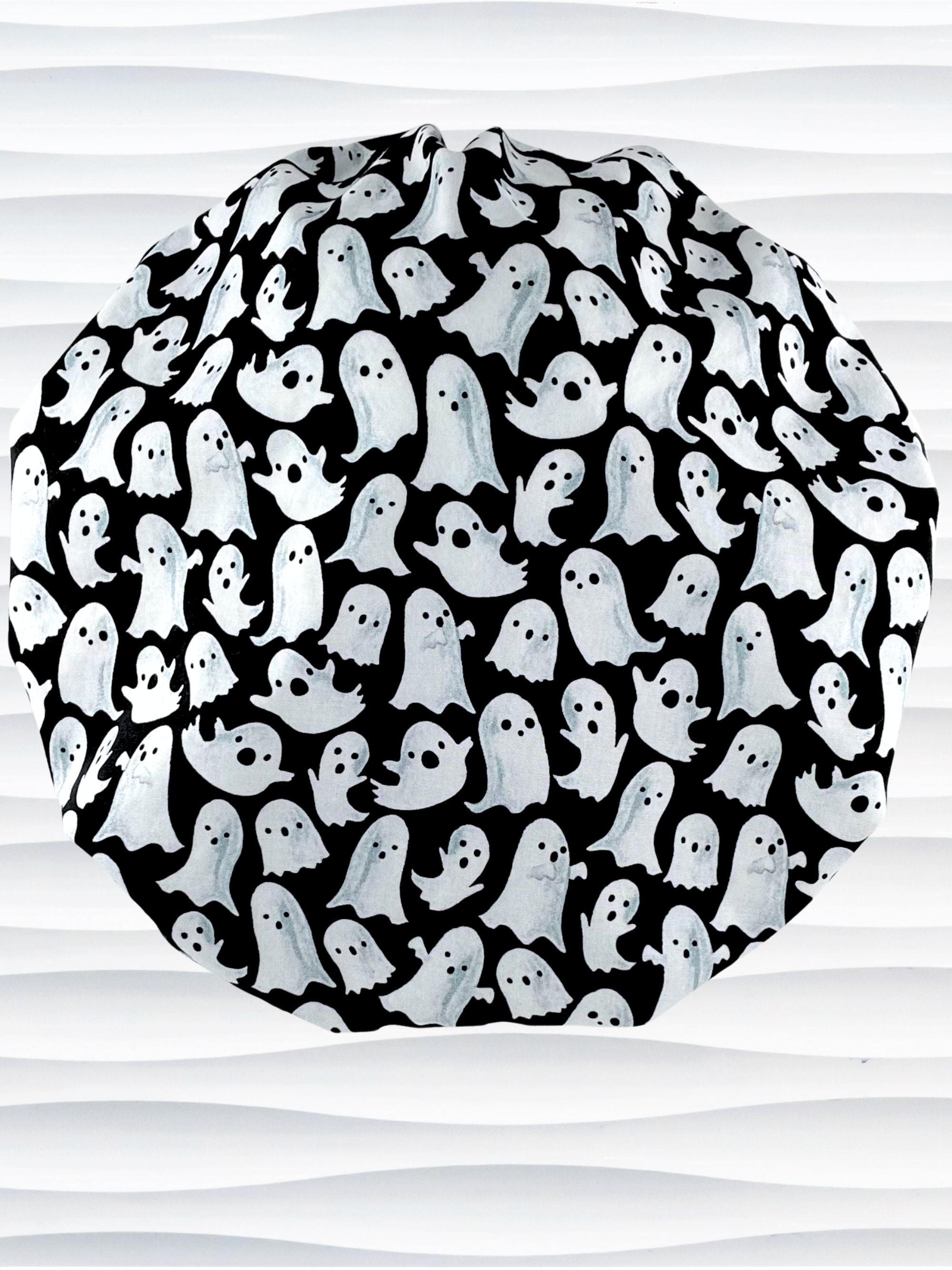 Bouffant style surgical scrub cap with white animated ghosts all over this black cotton fabric.