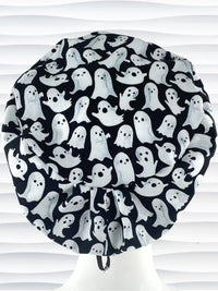Euro Pixie style surgical scrub cap with animated white ghosts tossed all over black cotton fabric