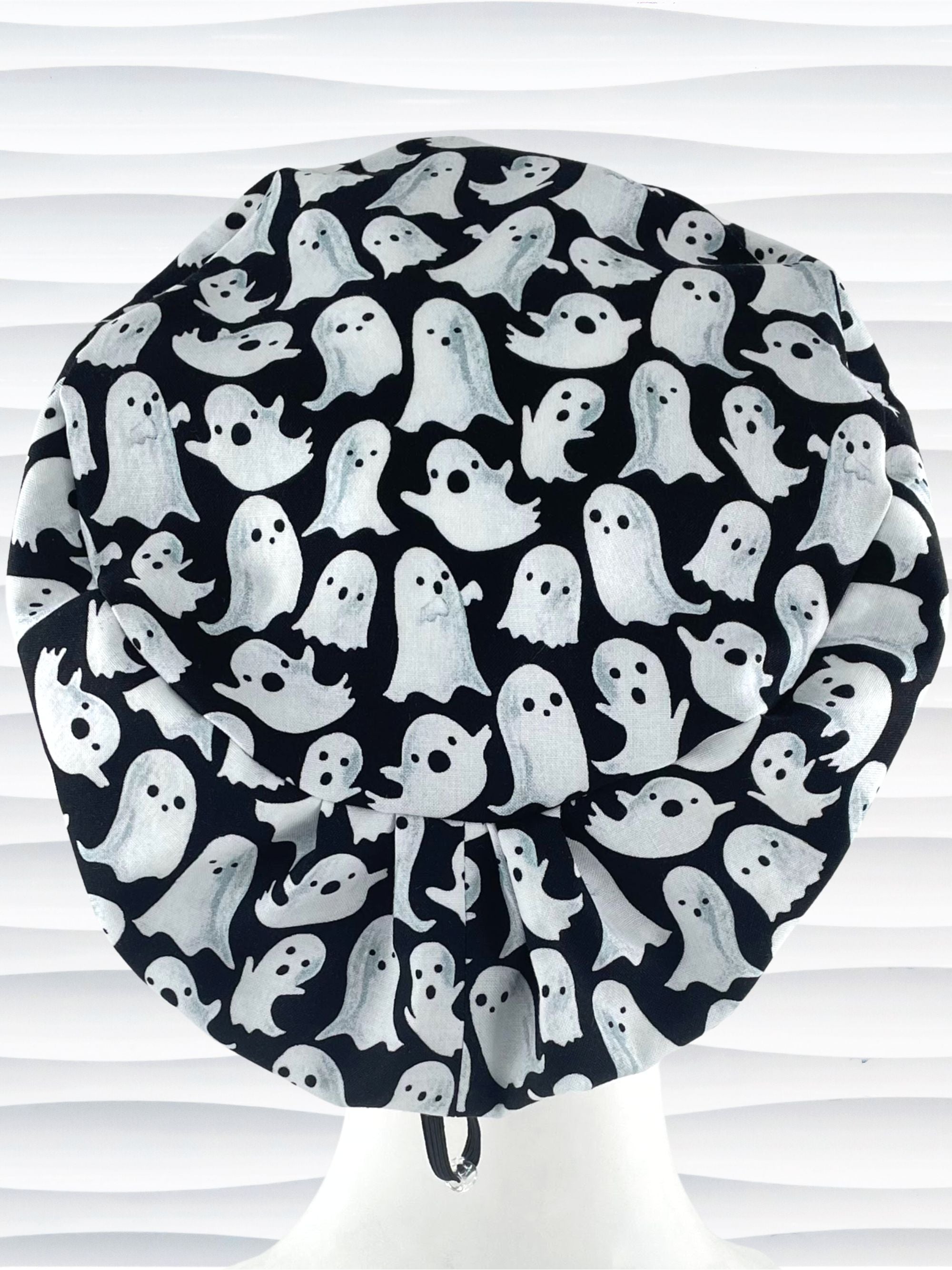 Euro Pixie style surgical scrub cap with animated white ghosts tossed all over black cotton fabric