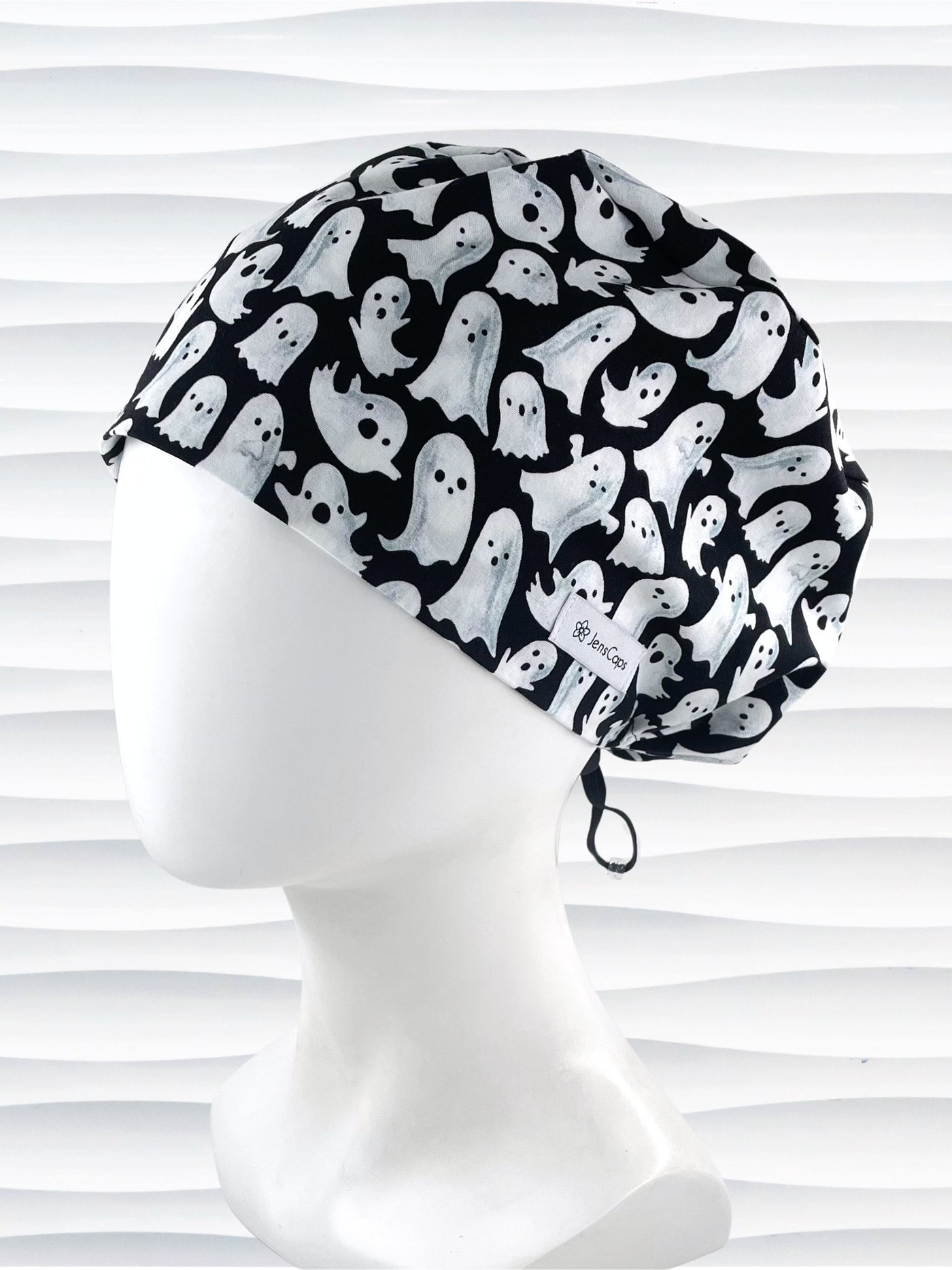 Euro Pixie style surgical scrub cap with animated white ghosts tossed all over black cotton fabric