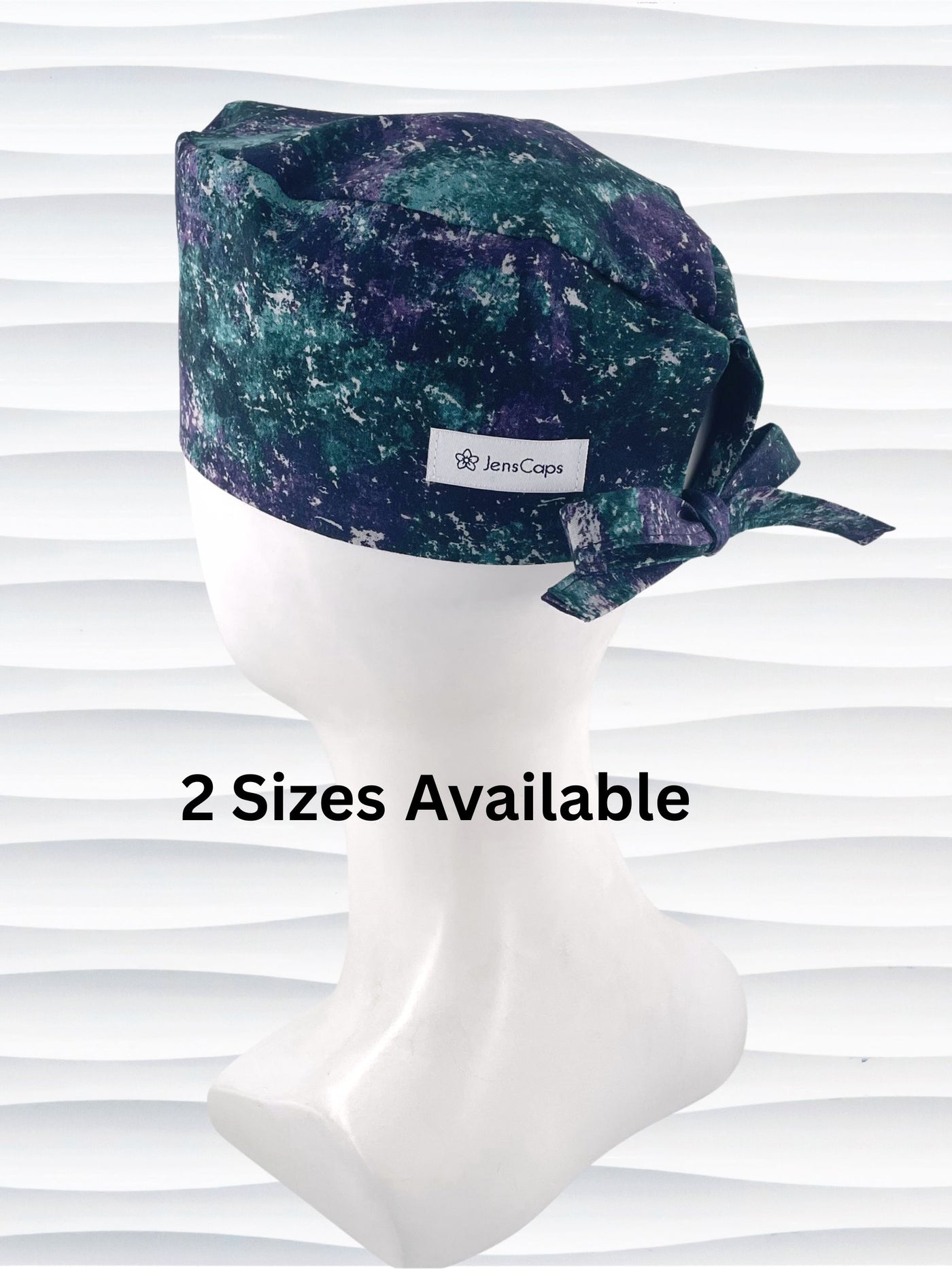 Surgeon style surgical scrub cap with an abstract print in teal, gray, and deep purples on cotton fabric.