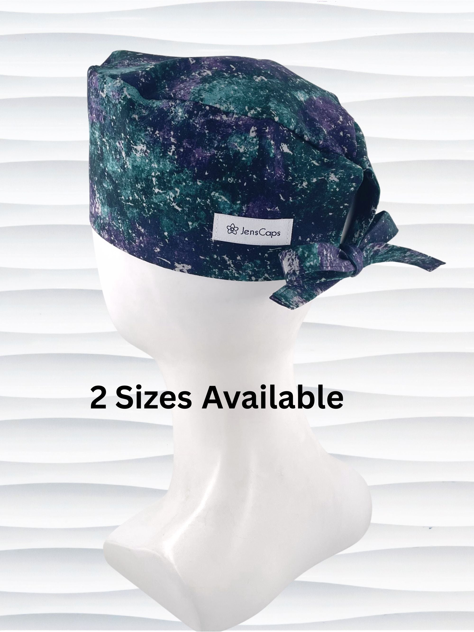 Surgeon style surgical scrub cap with an abstract print in teal, gray, and deep purples on cotton fabric.