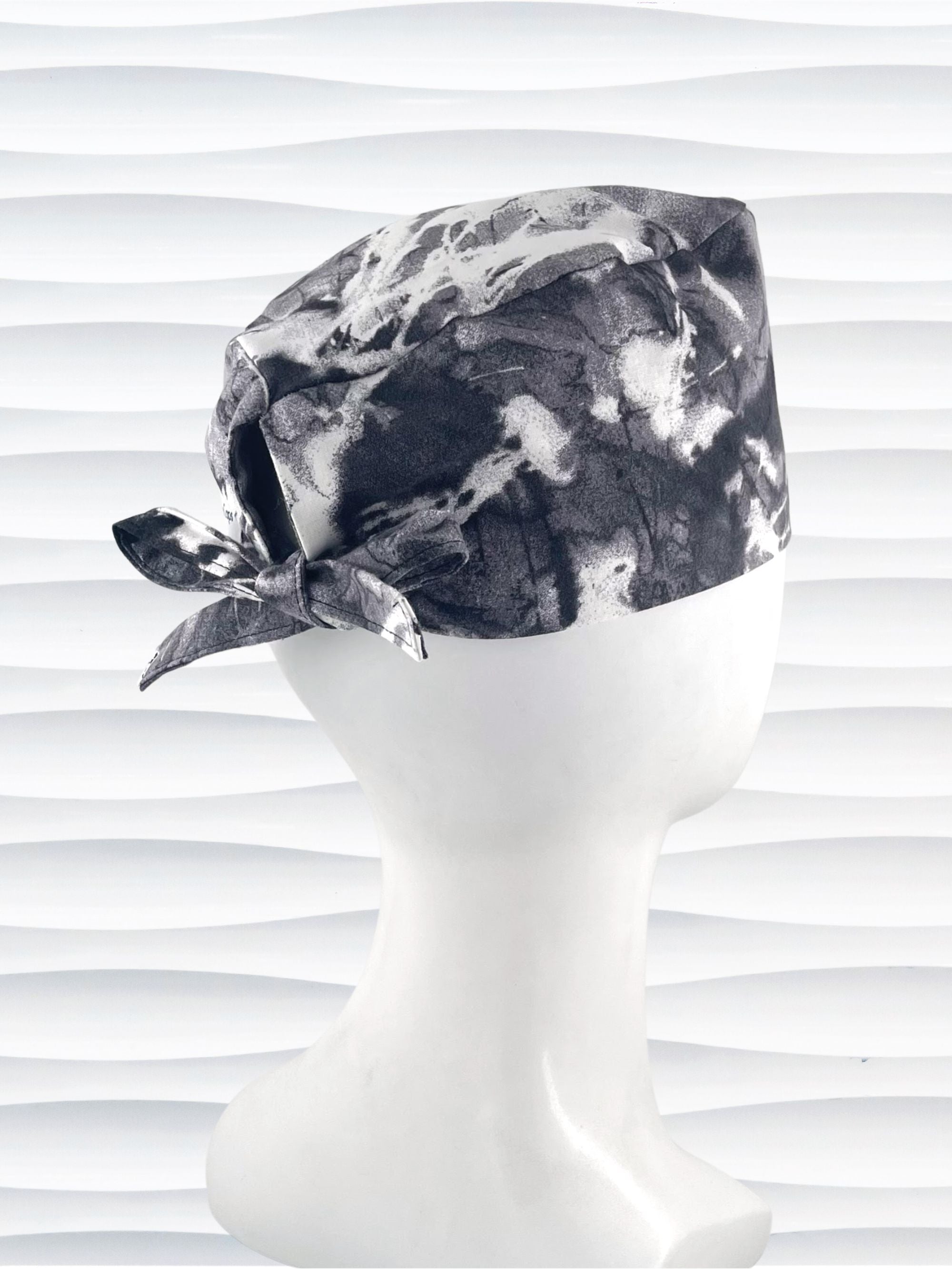 Mens surgeon style surgical scrub cap in an abstract print in black and white on cotton fabric.