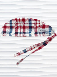 Surgeon style surgical scrub cap with a red and blue plaid print with white stars on cotton fabric.