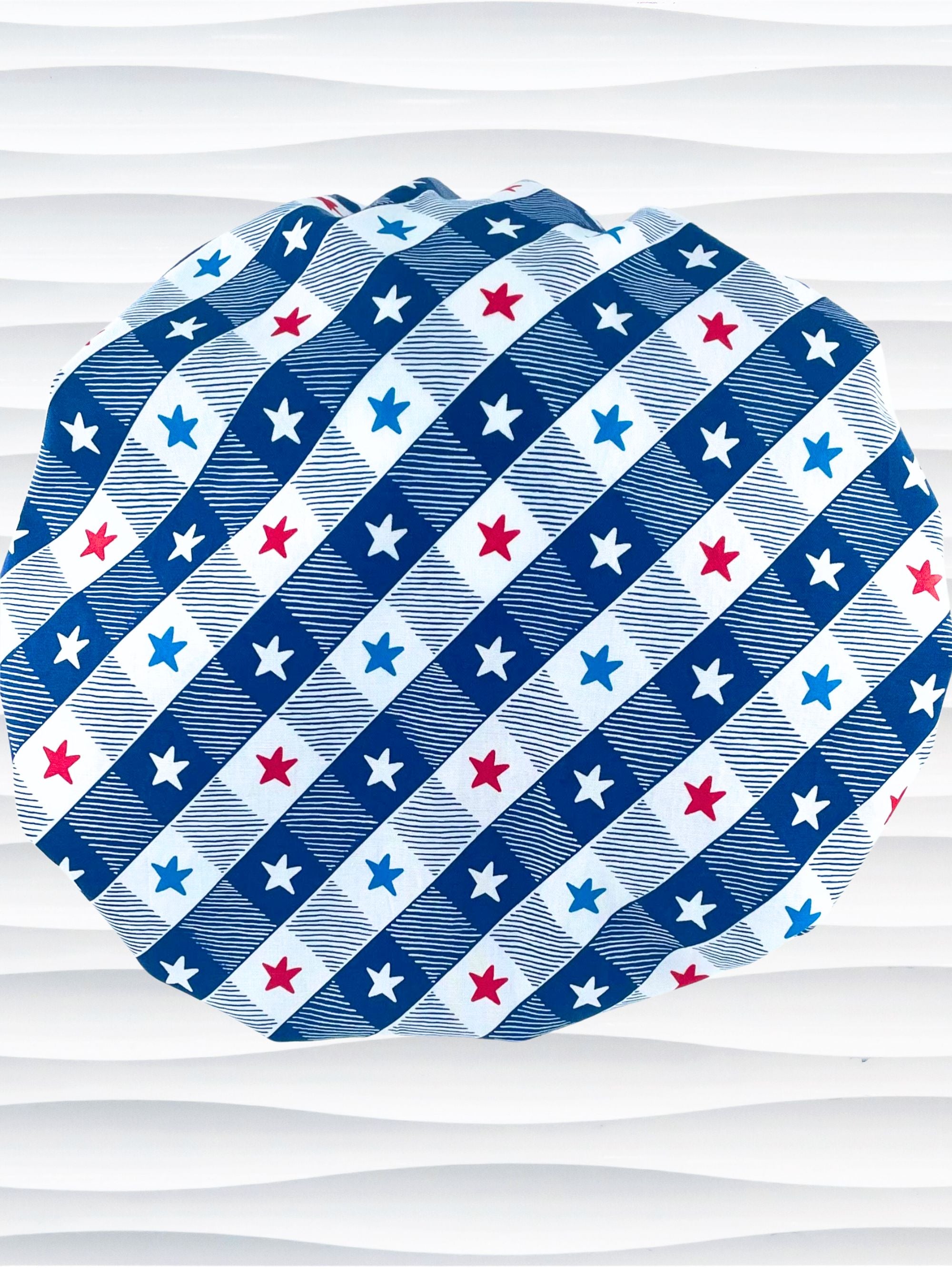 Bouffant style surgical scrub cap with patriotic stars in red white and blue in a modern blue and white buffalo plaid pattern on cotton fabric.