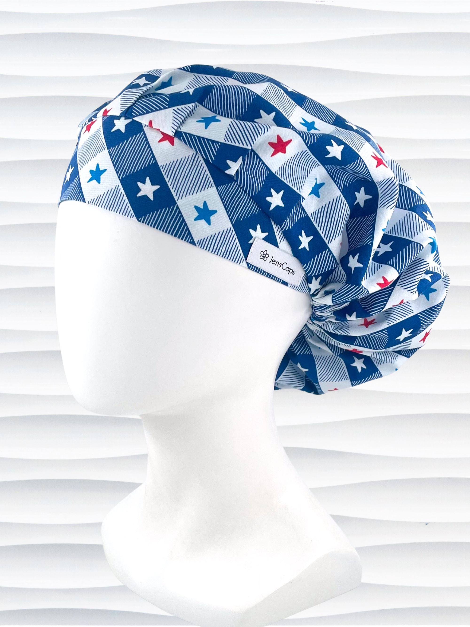 Bouffant style surgical scrub cap with patriotic stars in red white and blue in a modern blue and white buffalo plaid pattern on cotton fabric.